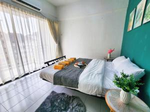 a bedroom with a large bed with pillows on it at Klang Prima Bayu Cozy 4-Room Retreat in Klang