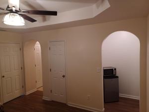 an empty room with a ceiling fan and a microwave at Luxury Suite in Austell