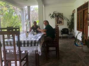 a man and a woman sitting at a table at Hamadhi guest in Haldummulla