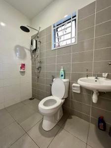 a bathroom with a toilet and a sink at Serene Homestay Semenyih - Endlot House 4BR for 9 pax in Semenyih