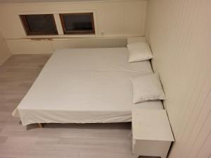 a small bedroom with a white bed and a window at One Bedroom Apartment Kjeller Lillestrøm - 2 mins from OSLOMET in Lillestrøm
