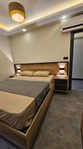 a bedroom with a large bed and two night stands at The bluesuıt in Mudanya