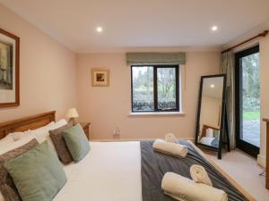 a bedroom with a bed and a large window at Gillybeck in Ambleside