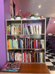 a book shelf filled with lots of books at Madam Guesthouse in Krabi