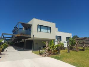 a white house with a fence in front of it at Waterline Property Portarlington in Portarlington