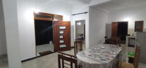 a room with a table with chairs and a kitchen at Gagana Vila 01 in Kandy +25 photos