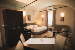 a hotel room with a bed and a living room at Sobe Bernarda in Varaždinske Toplice