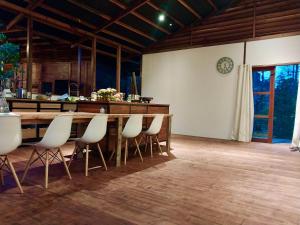 a dining room with a table and white chairs at Villa Luzo in Saonek