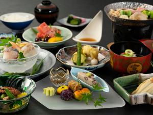 un tavolo con molti piatti di cibo sopra di Maple Arima a Kobe