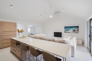 a living room with white furniture and a couch at Bay Village Resort Dunsborough in Dunsborough