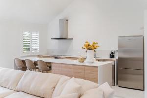 a white kitchen with a white couch in a room at Bay Village Resort Dunsborough in Dunsborough