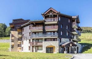 a building with balconies on the side of it at Les Résidences de Valmorel - maeva Home - 2 Pièces 5 Personnes Confort 74 in Valmorel