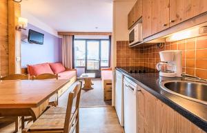 a kitchen and dining room with a table and a couch at Résidence Quartier Falaise - maeva Home - Studio 4 Personnes Confort MAE-3148 in Avoriaz +17 photos
