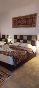 a bedroom with a large bed with a large headboard at Dana Tower Hotel in Dana