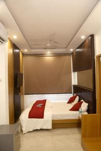 a bedroom with a large bed with red pillows on it at Bunk Hostel Delhi Best Backpacking Accommodation in New Delhi