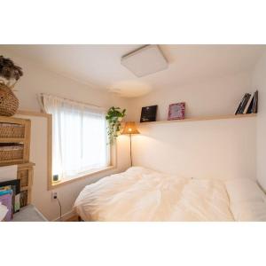 a bedroom with a white bed and a window at Studio Wolyoung in Jeju