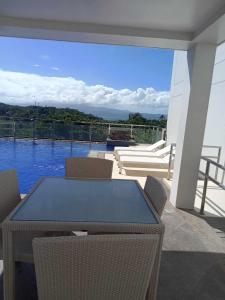 a table and chairs on a patio with a view at Ocean Garden Villa Condominium in Boracay