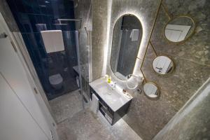 a bathroom with a sink and a mirror at Stile Suite Marine Hotel in Antalya