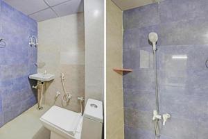 a bathroom with a shower and a toilet and a sink at Umen Hotel Sector 66 in Noida
