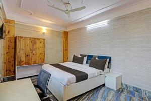 a bedroom with a large bed and a table at Umen Hotel Sector 66 in Noida