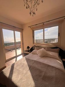 a bedroom with a bed with a view of an airport at ROSE VILLA - 3 BED POOL in Episkopi Limassol