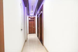 an empty corridor in a building with two doors at FabHotel KP Palace in Agra