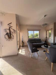a living room with a couch and a table at ROSE VILLA - 3 BED POOL in Episkopi Limassol