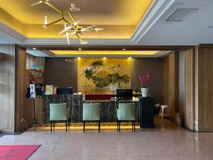 a lobby with a reception desk with chairs and a ceiling at Taitung Bali Suites Hotel in Taitung City