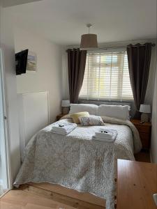 a bedroom with a large bed with a window at Golden Lion in Brixham
