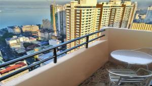 a balcony with a chair and a view of the city at Experience OCEAN VIEW Rooms in The Heart Of Manila, Enjoy FREE ACCESS To The POOL, SAUNA, PLUS MASSAGE PROMO In Prime Location Near The US Embassy, NAIA, Makati, BGC, Mall of Asia, And Chinatown This Is A Limited-Time Offer, Book Now in Manila