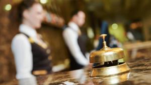 a bell sitting on top of a counter with two men at Experience OCEAN VIEW Rooms in The Heart Of Manila, Enjoy FREE ACCESS To The POOL, SAUNA, PLUS MASSAGE PROMO In Prime Location Near The US Embassy, NAIA, Makati, BGC, Mall of Asia, And Chinatown This Is A Limited-Time Offer, Book Now in Manila +95 photos