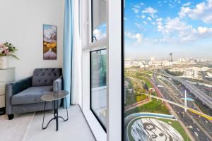 a living room with a couch and a window at FAM Living - 2 Bedroom Home close to Dubai Frame in Dubai