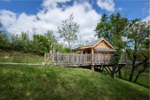 a wooden cabin on a bridge in a field at Gîte de France La cabane du causse 1 étoile - Gîte de France 2 personnes MAE-6394 in Lissac-sur-Couze
