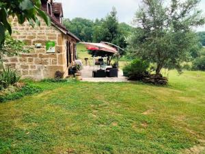 Cette maison en pierre possède une terrasse dans la cour. dans l'établissement Gîte de France à Saillac 3 épis - Gîte de France 4 personnes 444, à Saillac