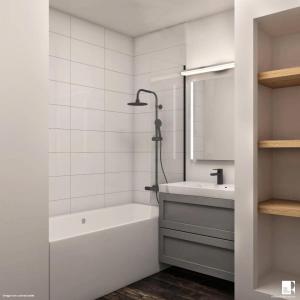 uma casa de banho branca com uma banheira e um lavatório em Résidence La Rivière - maeva Home - Appartement 2 pièces 6 personnes - Sé 71 em Chamonix-Mont-Blanc