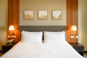 a bedroom with a bed with two white pillows at Shangri-La Tanjung Aru, Kota Kinabalu in Kota Kinabalu