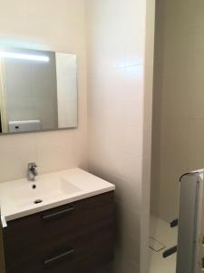 a bathroom with a white sink and a mirror at Résidence CHRISTIANIA - Studio pour 6 Personnes 964 in Gourette