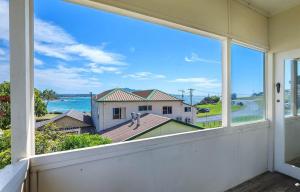 a view of the ocean from the balcony of a house at Bermagui Bay Beach House 2, Wonderful Beachside Location, Pet Friendly in Bermagui