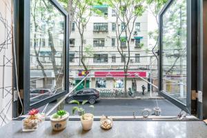 an open window with a view of a city street at Shanghai Hills&XING 1881 Homestay Near Line2 West Nanjing Rd in Shanghai