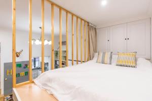 a bedroom with a large white bed in a room at Shanghai Hills&XING 1881 Homestay in Shanghai