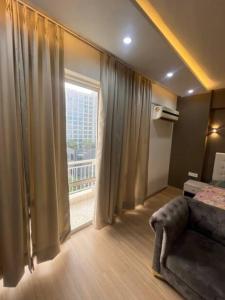 a bedroom with a bed and a large window at Westin Lucknow in Lucknow