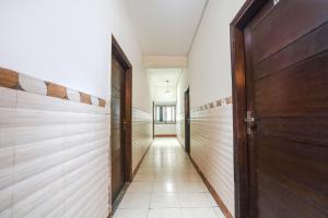 an empty hallway with wooden walls and a door at FabHotel Sai Residency in Agra