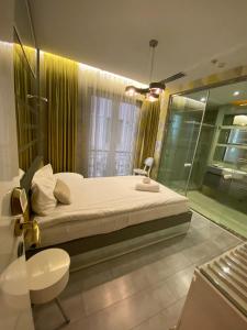 a bedroom with a large bed and a shower at Golden Pars Hotel in Bursa