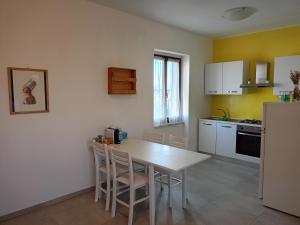 a kitchen with a table and chairs in a room at Avenza Dream in Carrara