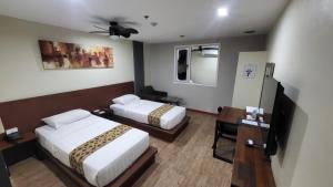 Postel nebo postele na pokoji v ubytování DG Grami Hotel