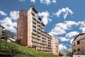 a tall building on a hill next to some buildings at Résidence Le Cédrat - maeva Home - Appartement 2 Pièces 4 Personnes - Conf 17 in Avoriaz