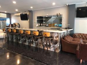 a bar with a bunch of chairs and a counter at The Freelancer Hotel in Pattaya Central