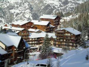 a group of buildings with snow covered roofs at Résidence Thabor - Studio pour 3 Personnes 704 in Modane