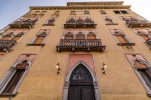 a tall building with a door and a balcony at Palazzo Boito Luxury Apartment Lido Venice view Loc14132 in Venice-Lido