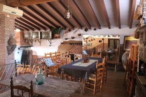 a restaurant with tables and chairs in a room at El Regajo in Ayora